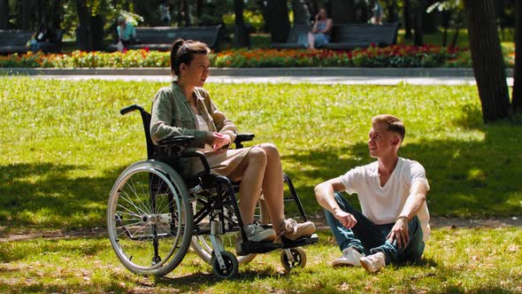 Woman in a Wheelchair and Her Friend Spending Time at the Summer Park