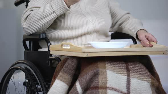 Lonely Elderly Woman in Wheelchair Eating Dinner and Crying, Health Problems