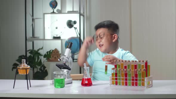 Excited Cute Little Scientist Boy Mixes Chemicals In Test Tube