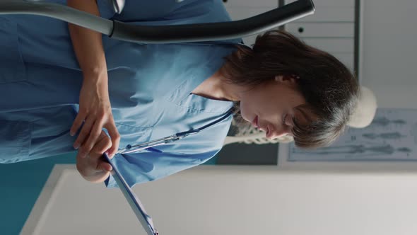 Vertical Video Portrait of Female Nurse Preparing to Treat Patient with Mechanical Disorders