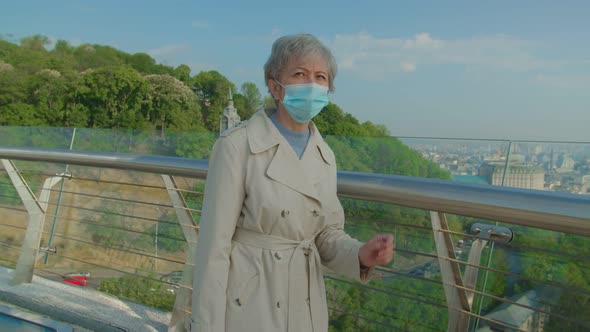 Elderly Vaccinated Woman Putting Off Mask to Breath Fresh Air