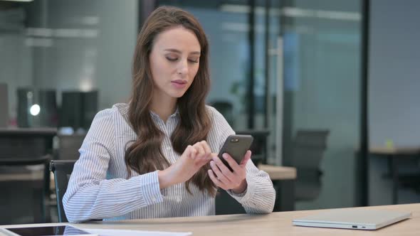 Upset Young Businesswoman Reacting to Loss on Smartphone