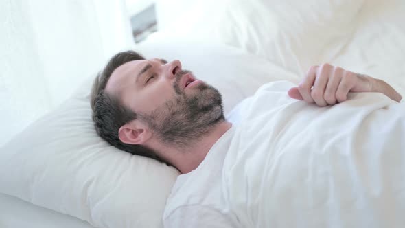 Portrait of Beard Young Man Having Nightmare in Bed 