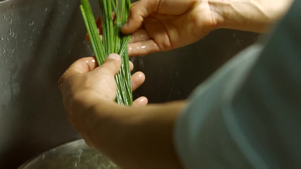 Man's Hands Wash Green Onion.