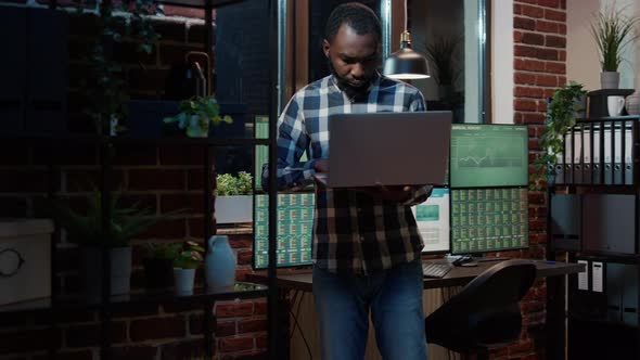 Hedge Fund Trader Looking at Real Time Stocks Numbers on Laptop