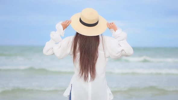 Asian woman enjoy around beautiful beach sea ocean