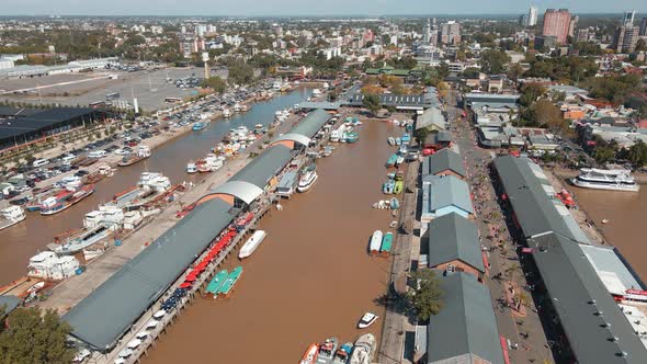 Aerial establishing shot of Puerto de Frutos, a touristic market in Tigre city, Argentina
