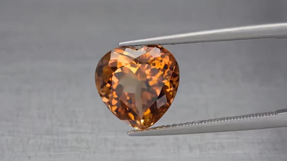 Imperial Champagne Yellow Topaz Heart Cut in the Turning Tweezers