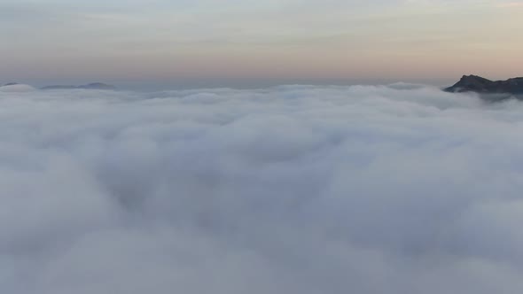 Sunset Time. Thick Dense Fog Enveloped the Coast. To Take Off Above the Clouds, Rising Upwards, a