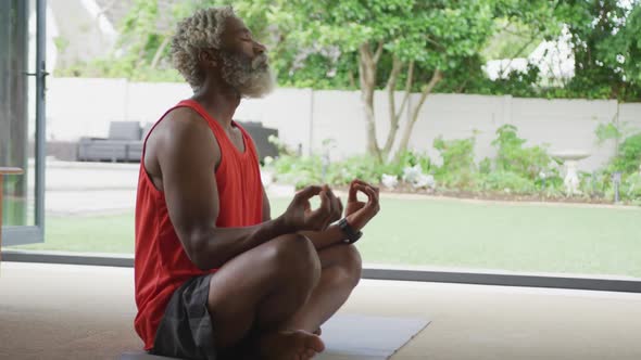 Video of african american senior man meditating