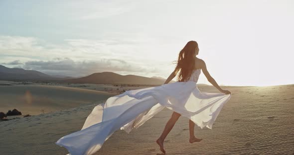 Charismatic Lady with a Long White Dress Running