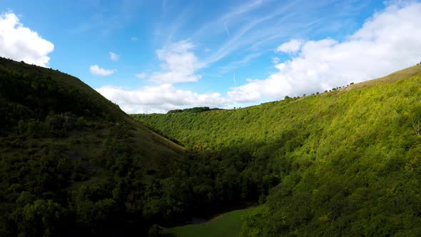 Aerial flight through a valley in the Derbyshire Peak District National Park, commonly used by cycli