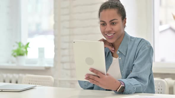 Young African Woman Doing Video Chat on Tablet