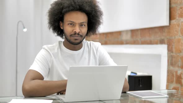 African Man in Office Looking at Camera