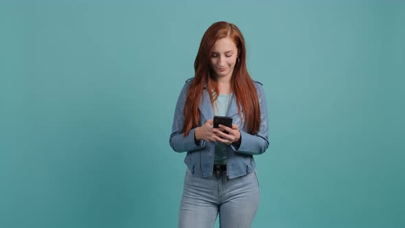 Young Happy Woman Using Smartphone. Excited Surprised Girl Texting on Her Phone.