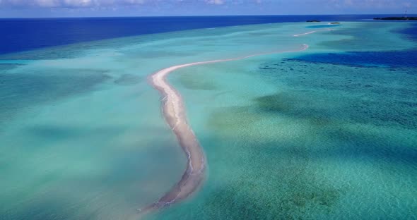 Daytime overhead abstract view of a white paradise beach and turquoise sea background in colorful 4K