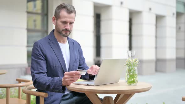 Man Making Successful Online Payment on Laptop