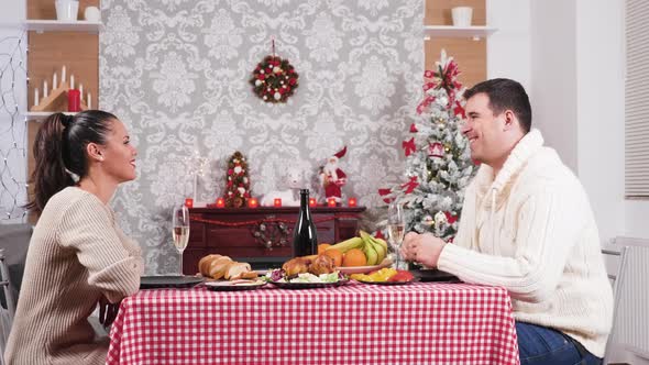 Beautiful Caucasian Couple Talking and Having Fun at the Christmas Dinner