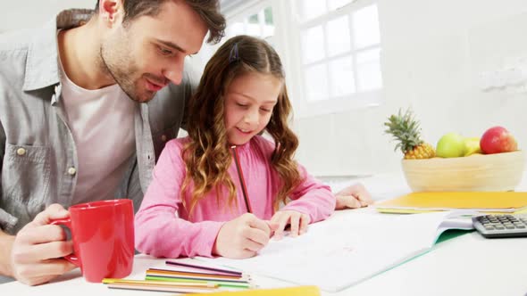 Father helping daughter with homework