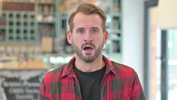 Portrait of Upset Young Man Feeling Shocked