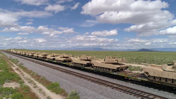 Military tanks lined up on train in the Utah desert