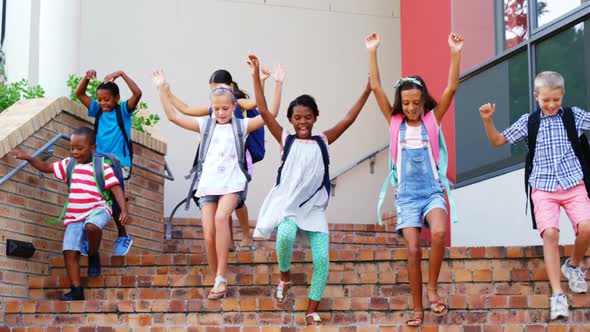 Group of kids getting down from staircase