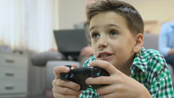 Boy Playing Videogame, Grandpa Using Laptop on Background, Lack of Communication