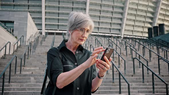 Portrait of a Mature Woman Looking at the Phone
