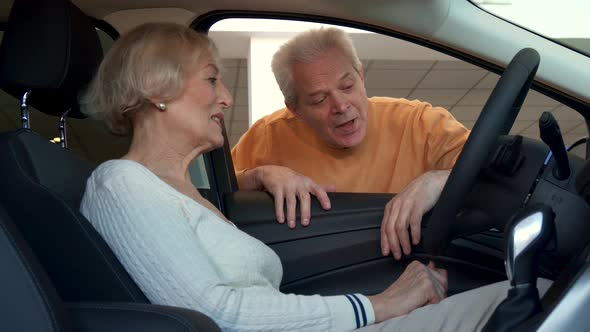 Senior Woman Sits Inside the Car