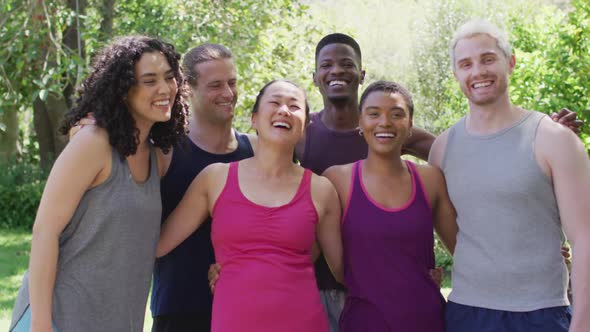 Portrait of group of diverse young people smiling while standing together at the park