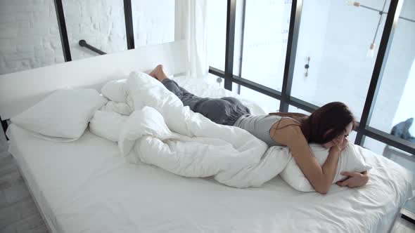 Beautiful Woman Lying On Comfortable Bed And Hugging Pillow