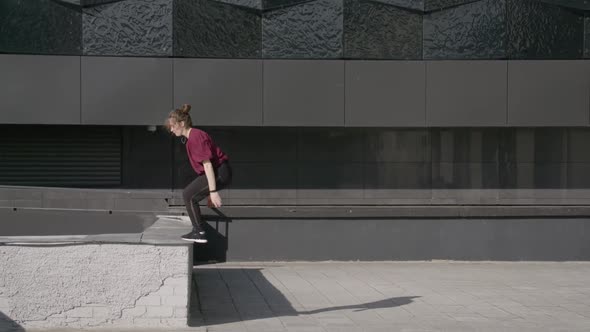 Young Female Gymnast Doing a Backflip Girl Doing a Somersault  Slow Motion Cityscape Side View