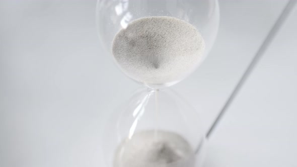 Hourglass sand falling in slow motion from above