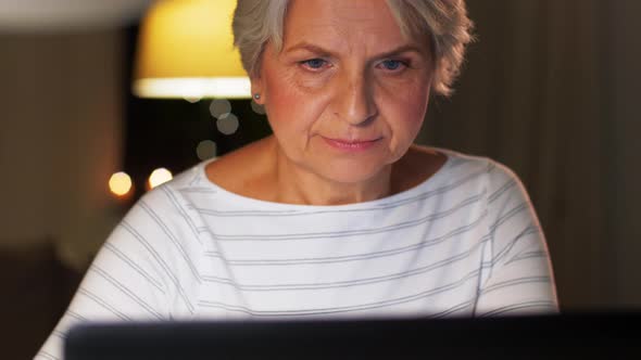 Senior Woman with Laptop and Coffee at Home