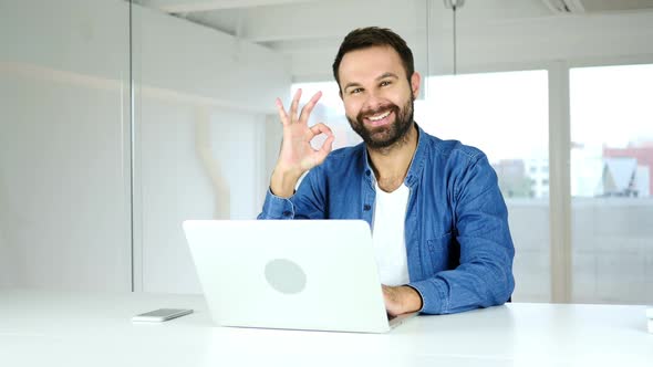 Okay Sign Satisfied Man Sitting in Office