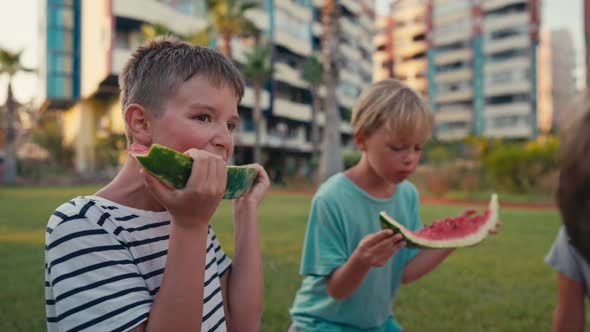 Four School Children Eating Watermelon Outdoor at Summer Time Happy Summer Concept