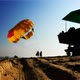 1Silhouettes of people on the beach. They inflate and lift the parachute into the air.  - VideoHive Item for Sale