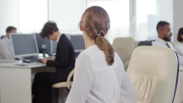 Businesswoman Stretching at Workplace