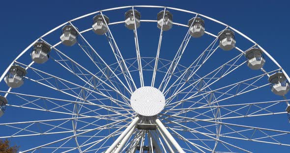 Ferris wheel in action againts a blue sky.