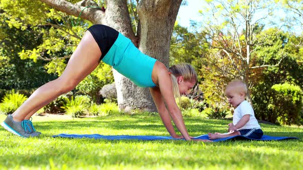 Woman exercising with her baby