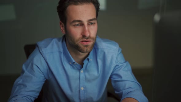 Pensive man working on laptop in office