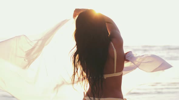 Woman in Bikini Swimsuit with Pareo on Beach
