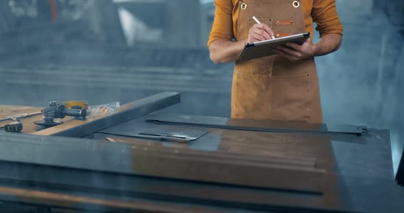 Metal Industry Worker with a Digital Tablet at the Plant