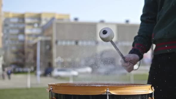 Hands Begin to Beat the Drum Water is Poured Onto the Drum and Sprayed