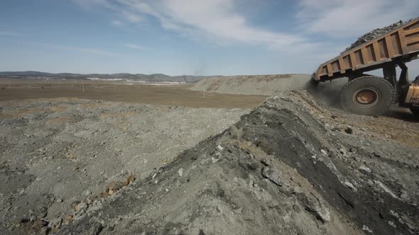 Multiton Dump Truck Lifts Body Unloads Waste Rock and Leaves