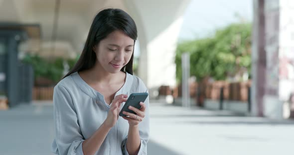 Woman use of mobile phone in the city