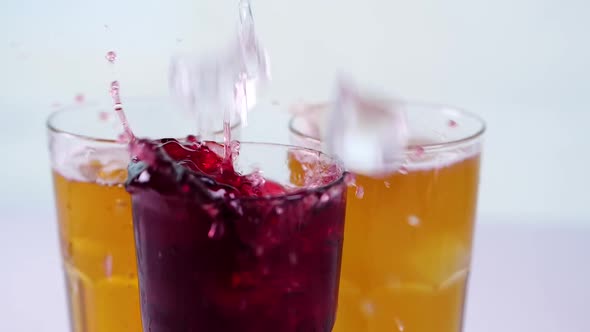 Ice Falling Into Glass Cups