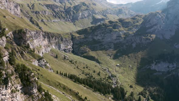 Drone shot over rough green Swiss mountains