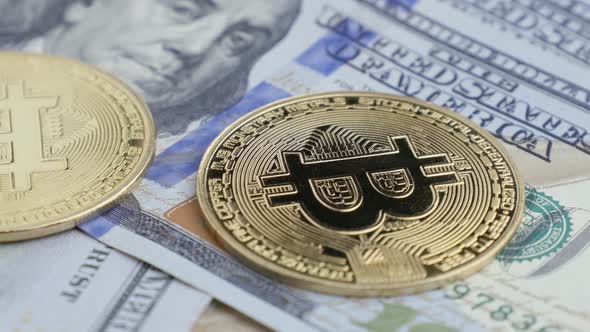 One hundred US dollars and Bitcoin BTC coins, cryptocurrency market and virtual money