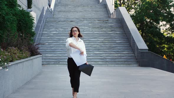 Emotional Businesswoman in Glasses Formal Attire and High Heels